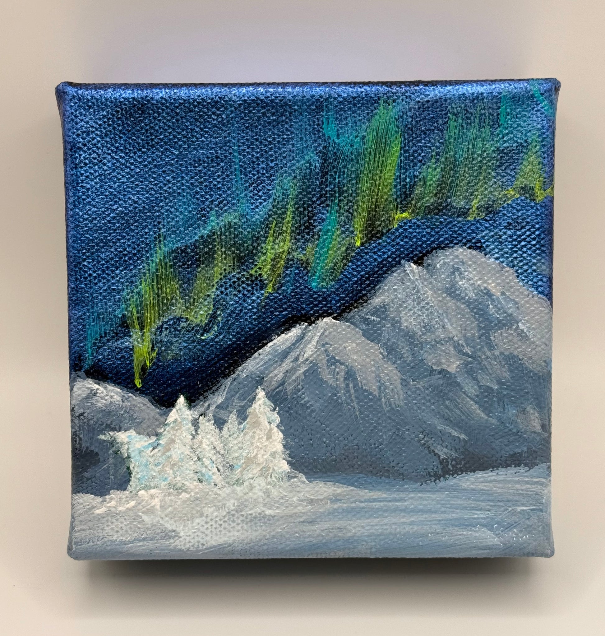 Front of painting auroras over mountians
