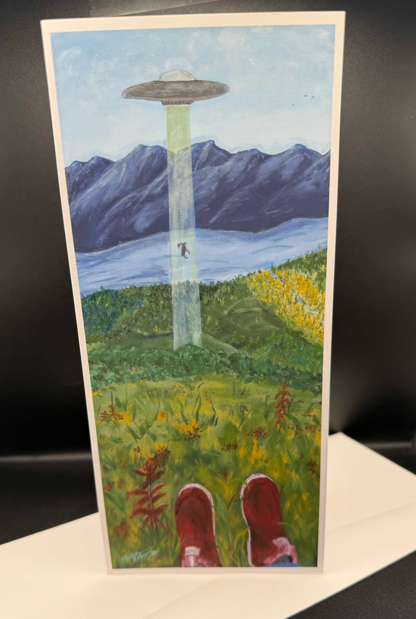 ARTISTIC REPRESENTATION OF A MOOSE BEING BEAMED UP BY A UFO IN ALASKA WILDERNESS.