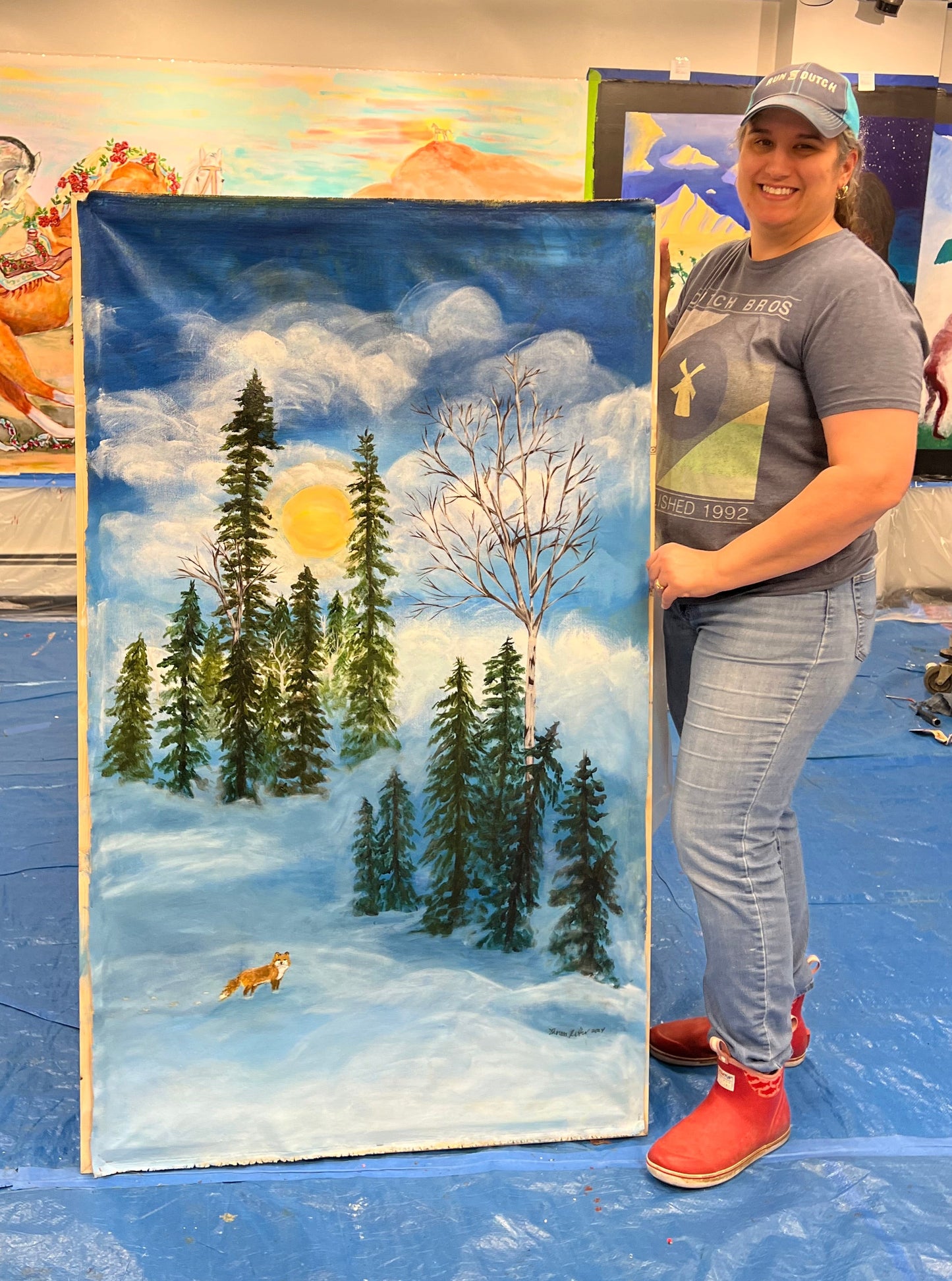 Artist displaying work in progress of fox mural