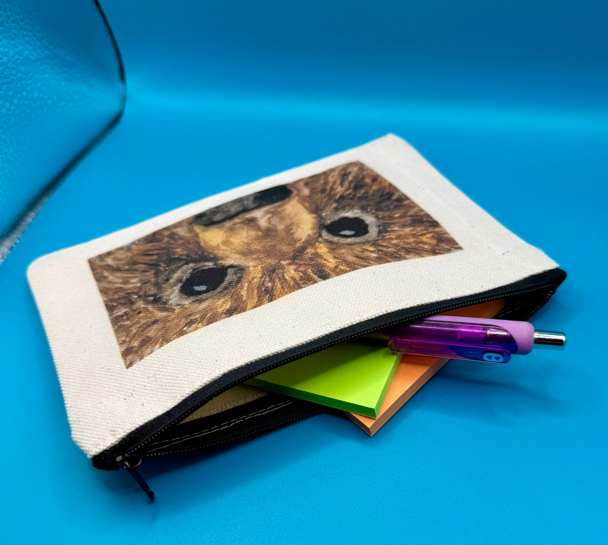 Small canvas zippered pouch featuring bear face original art called Hugo by Theresa Ritter