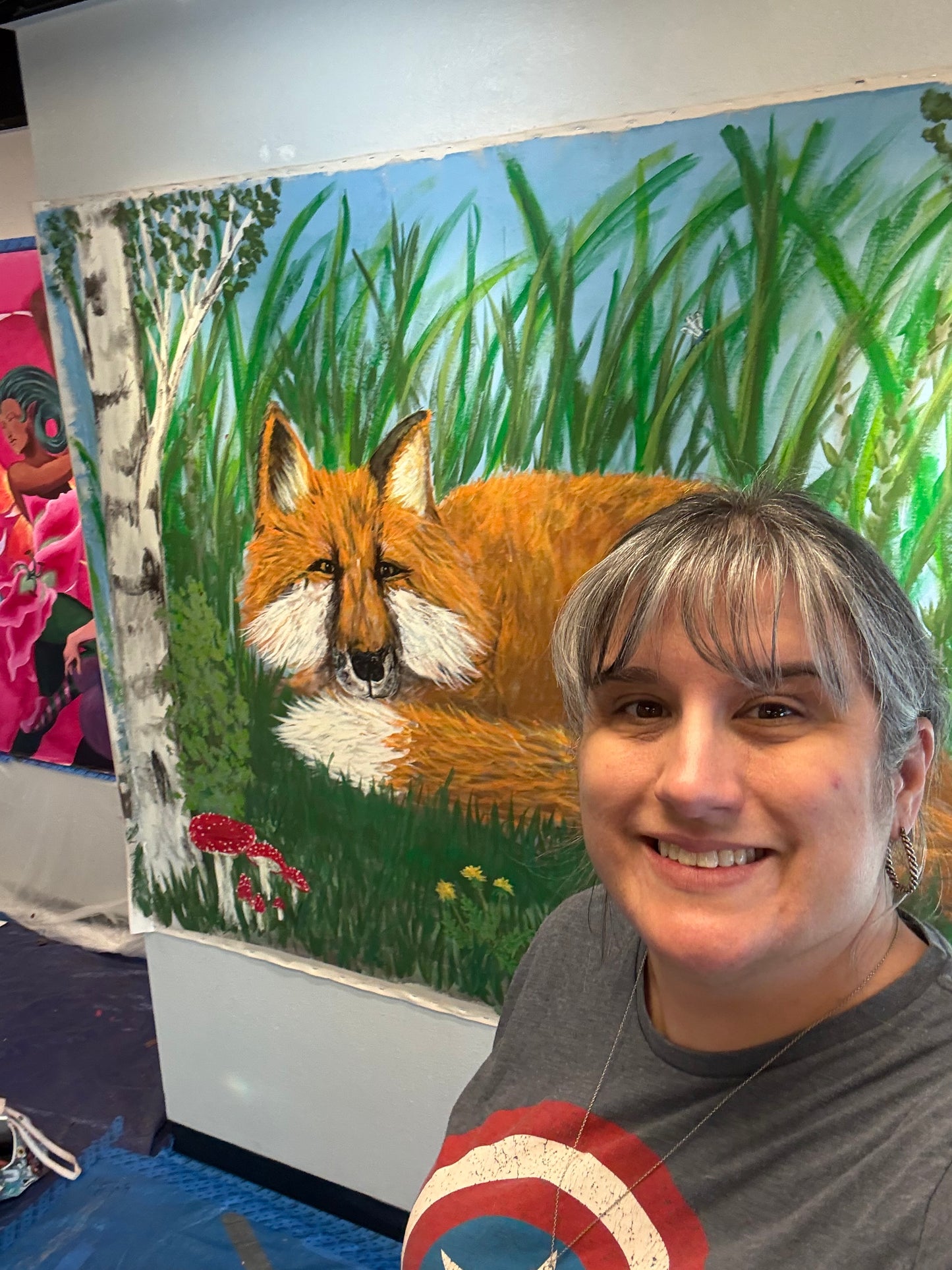 Standing in front of fox mural to show how big art is.