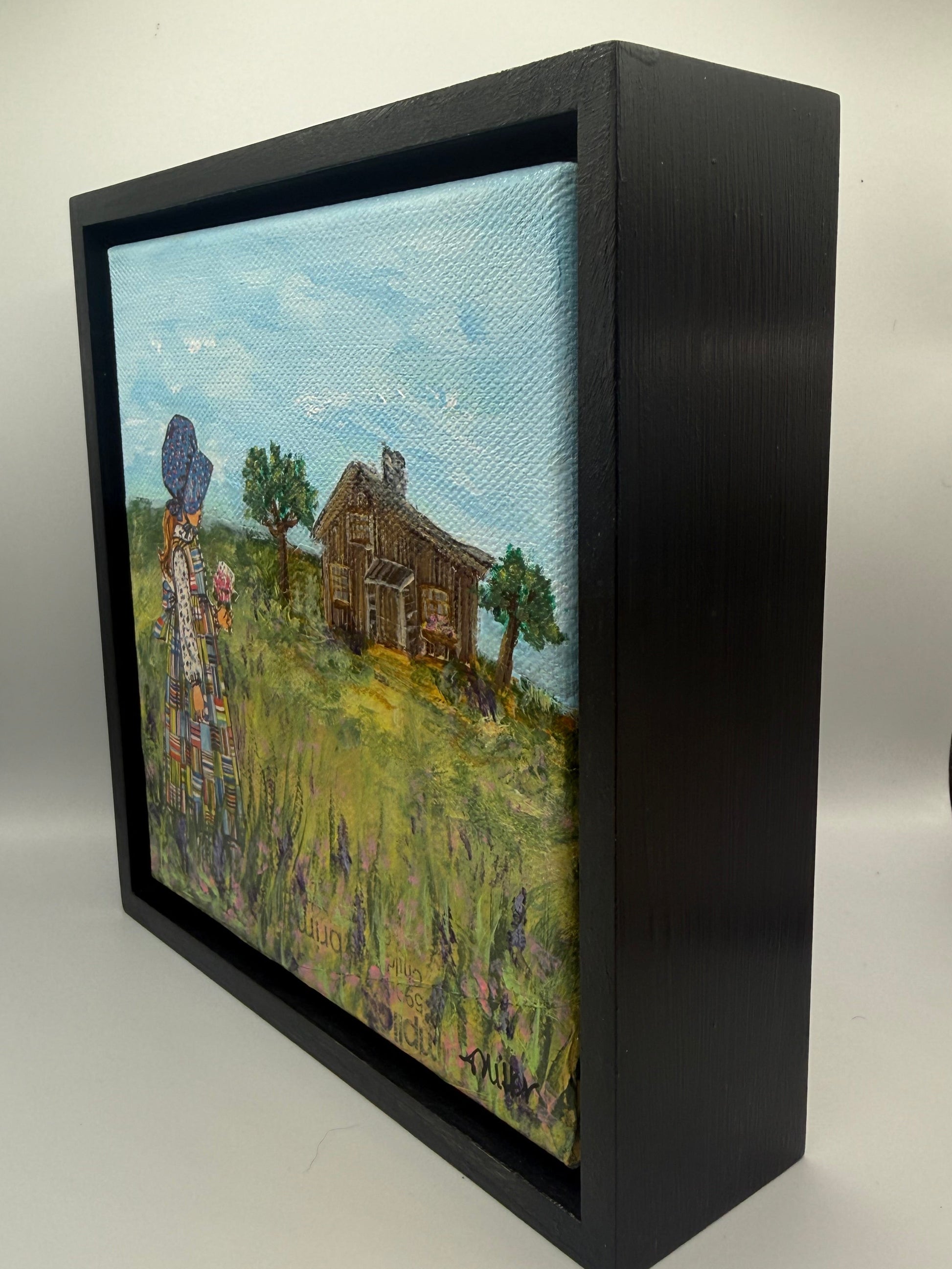 Mixed media painting of girl standing among prairie grasses.