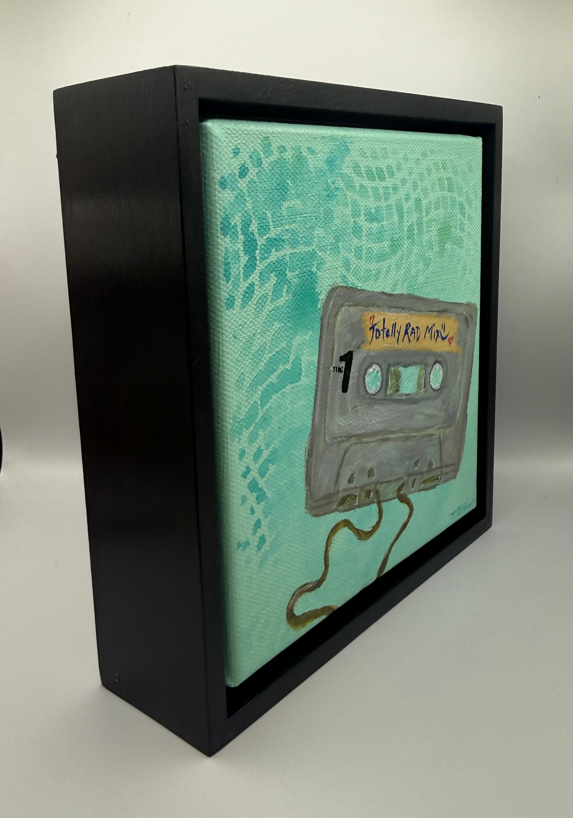 Sideview of frame with artwork depicting mix tape cassette