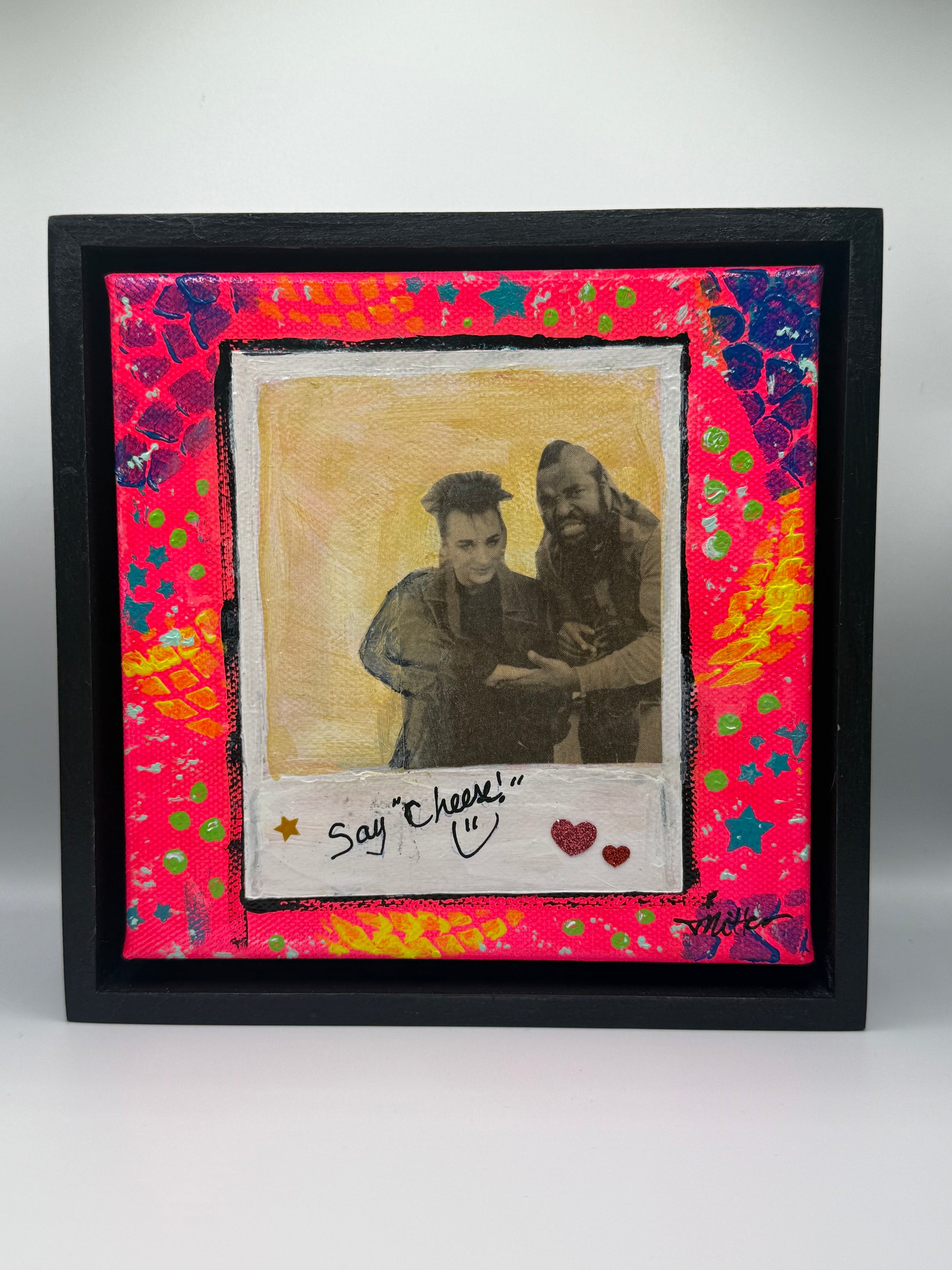 Mixed media art work featuring collage, stencil and 80’s icons with frame.